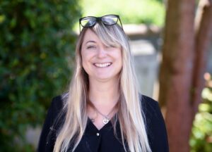 Photograph of Kate Faust in front of trees